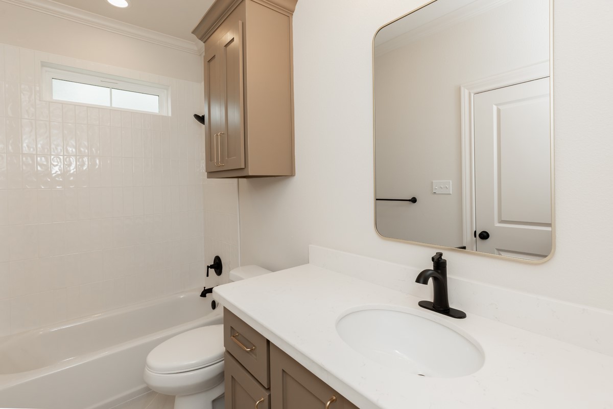 6560 Brayfield Lane Beaumont, TX 77706 - Photo 28 of 38 a bathroom with a granite countertop sink a toilet and a bathtub