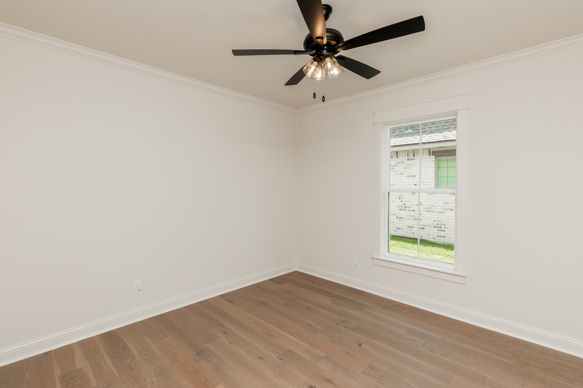 6560 Brayfield Lane Beaumont, TX 77706 - Photo 33 of 38 an empty room with a window and a fan
