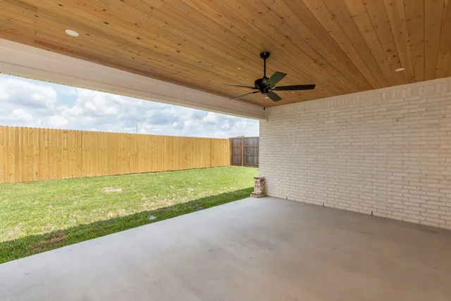 a view of a livingroom with a ceiling fan and window