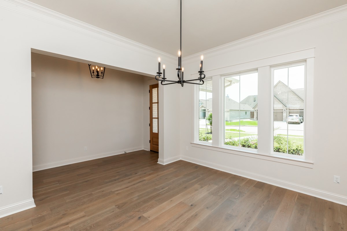 6560 Brayfield Lane Beaumont, TX 77706 - Photo 5 of 38 an empty room with wooden floor fan and windows