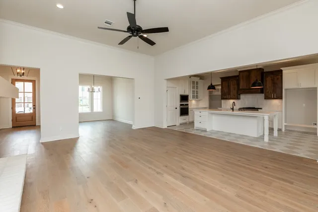 a view of empty room with wooden floor and window