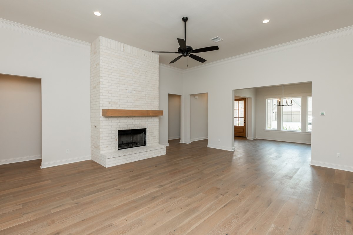6560 Brayfield Lane Beaumont, TX 77706 - Photo 9 of 38 a view of an empty room with wooden floor fireplace and a window