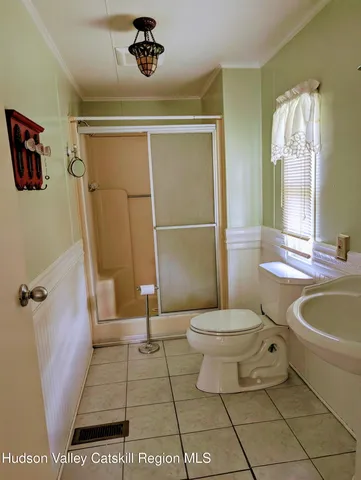 a bathroom with a toilet a sink and shower