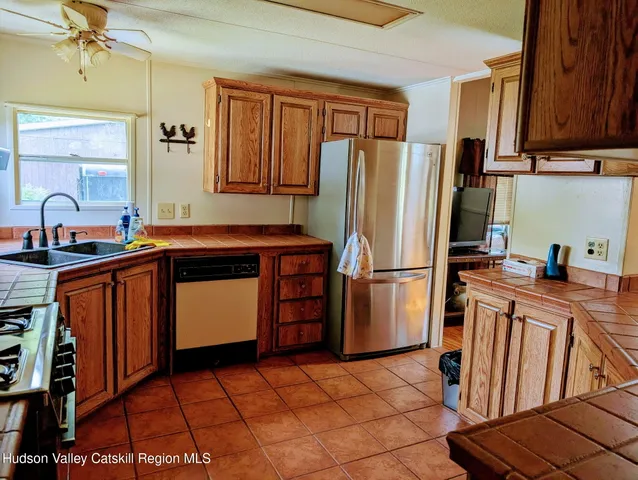 a kitchen with stainless steel appliances a refrigerator and a sink
