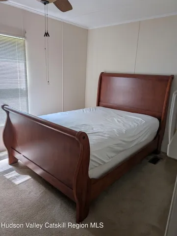 a bedroom with a bed and chair