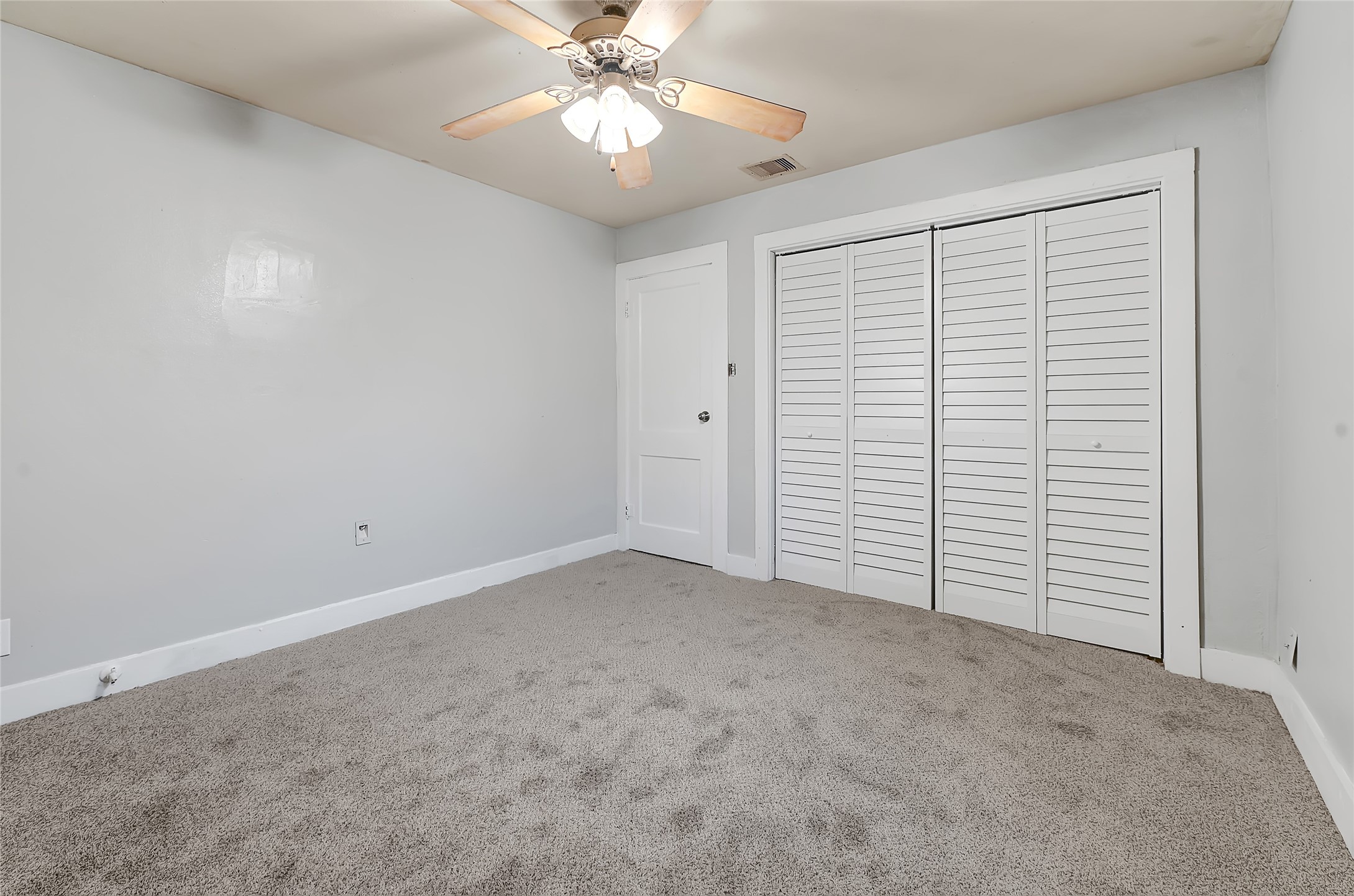 6825 Appleton Street Houston, TX 77022 - Photo 12 of 25 an empty room with a ceiling fan and a window