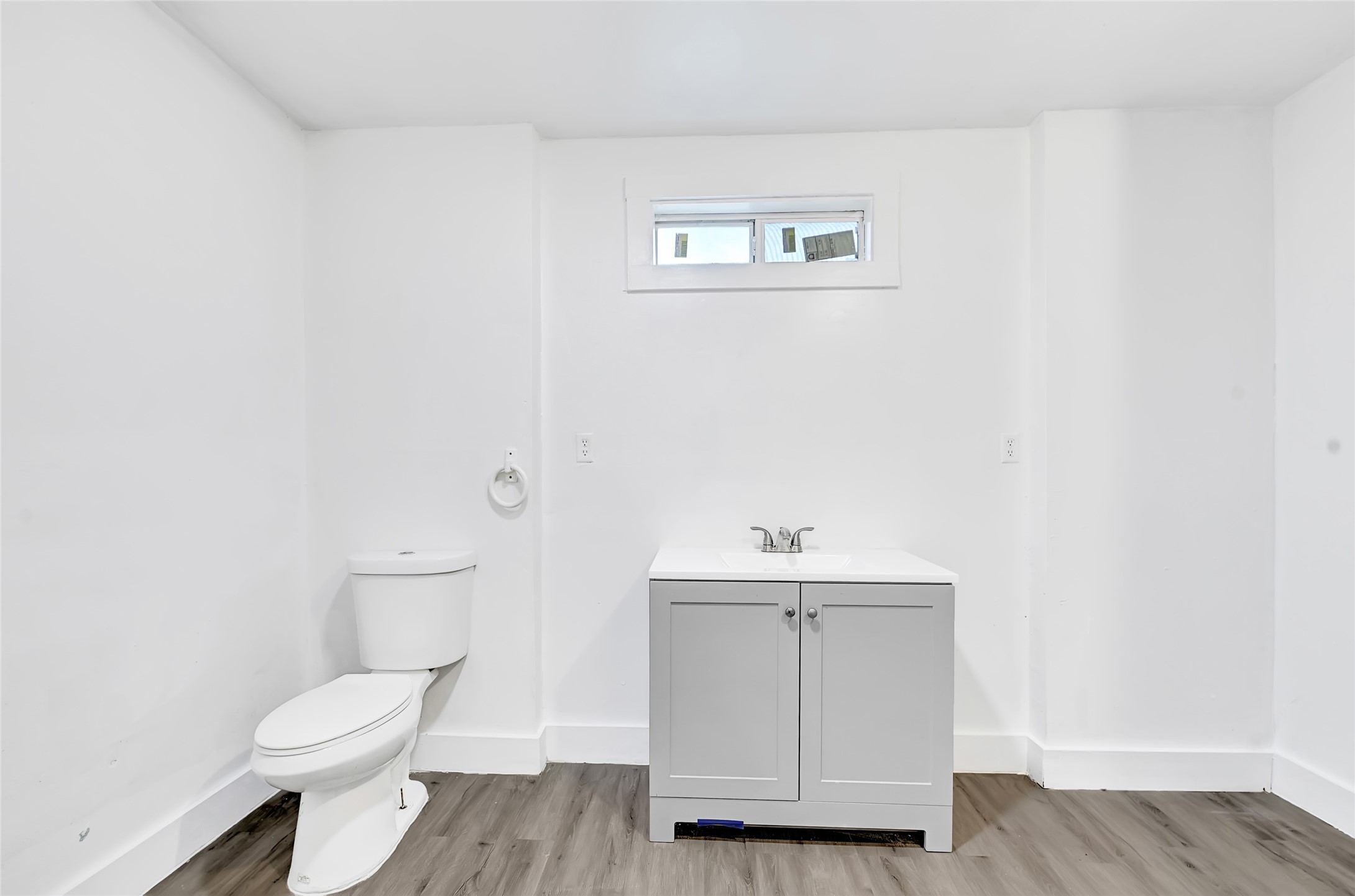 6825 Appleton Street Houston, TX 77022 - Photo 13 of 25 a white toilet sitting next to a bathroom sink