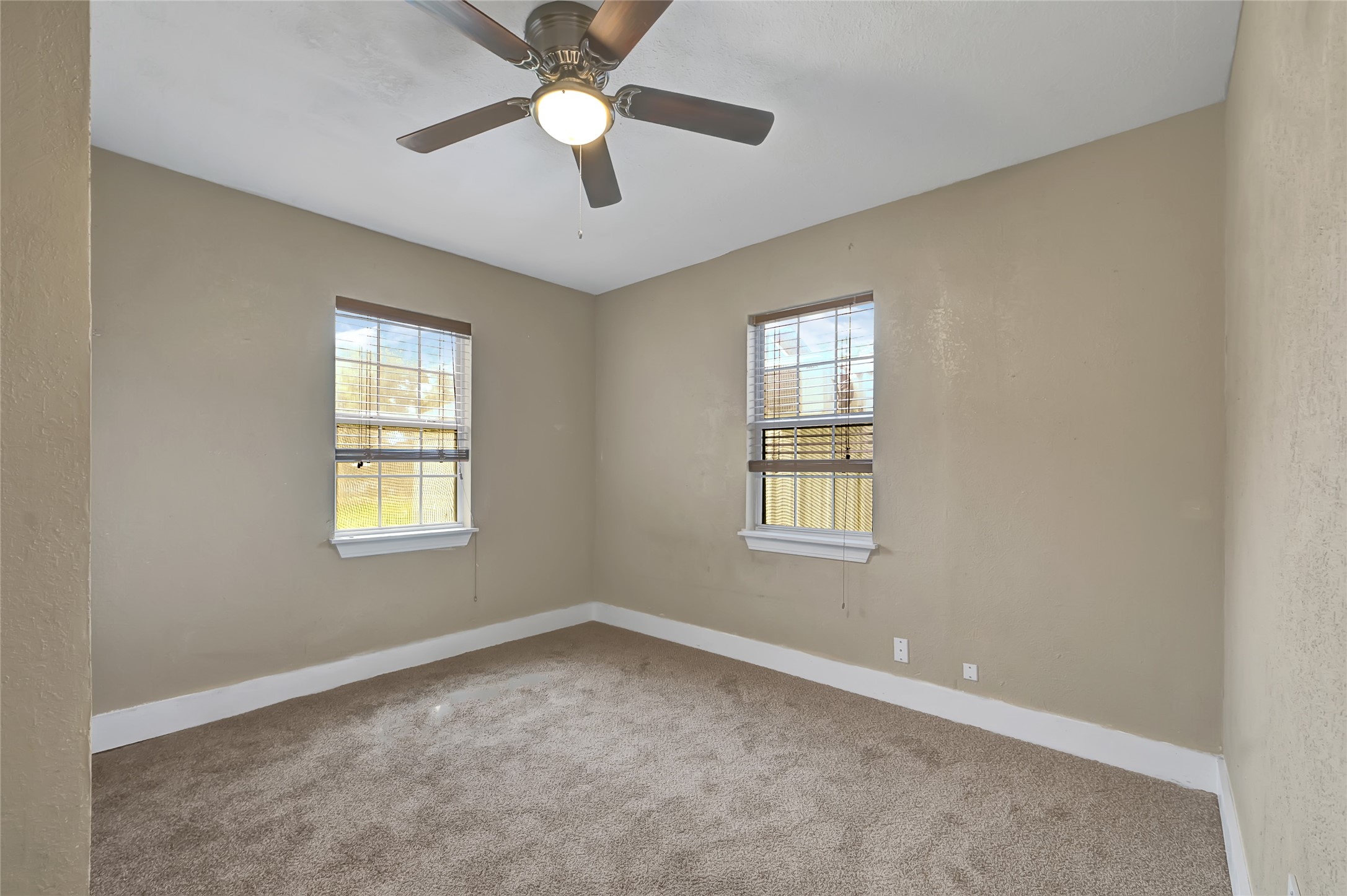 6825 Appleton Street Houston, TX 77022 - Photo 16 of 25 an empty room with a window and a fan
