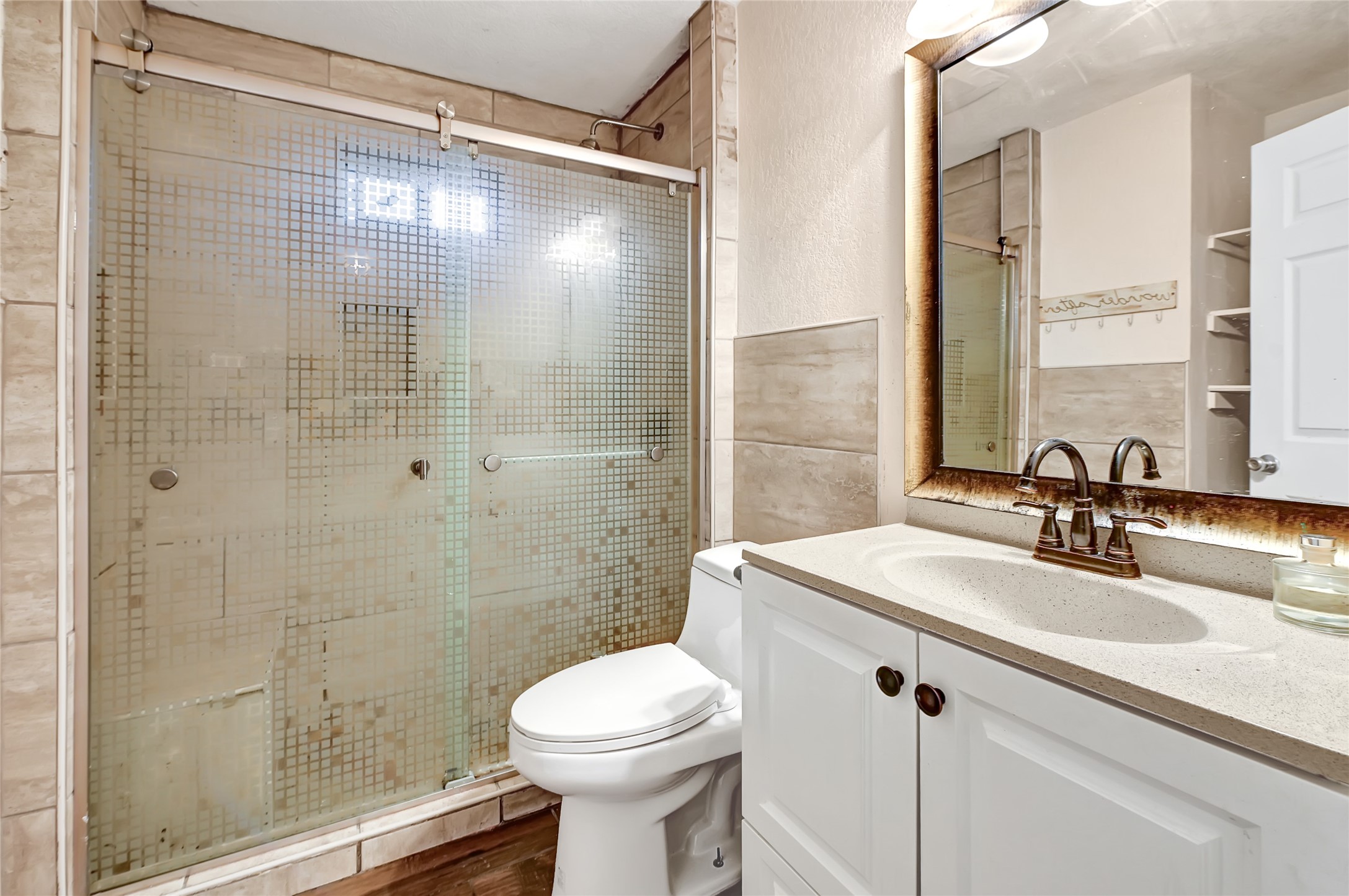 6825 Appleton Street Houston, TX 77022 - Photo 17 of 25 a bathroom with a sink mirror toilet and shower