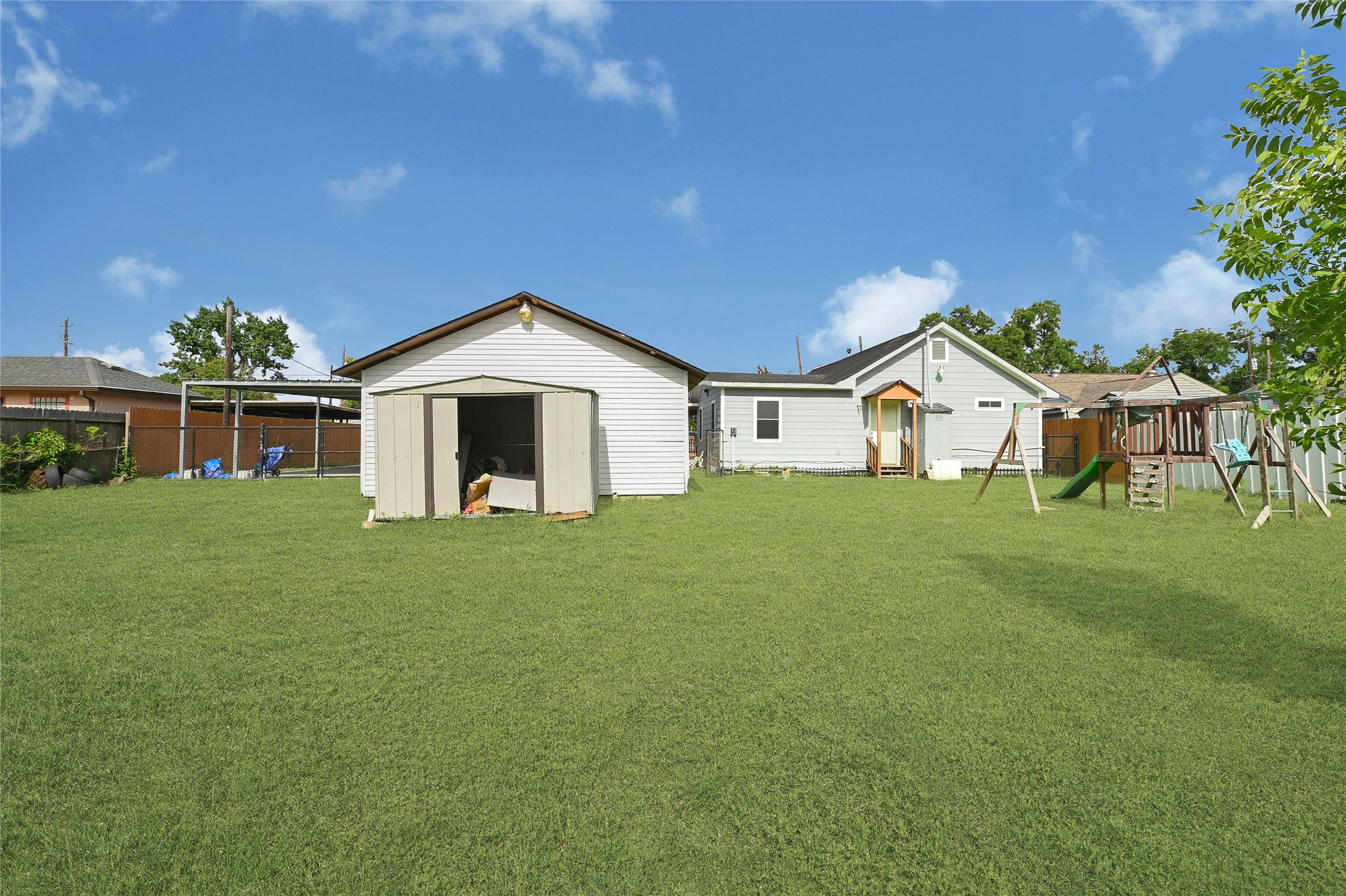 6825 Appleton Street Houston, TX 77022 - Photo 24 of 25 a view of a white house with a yard and potted plants