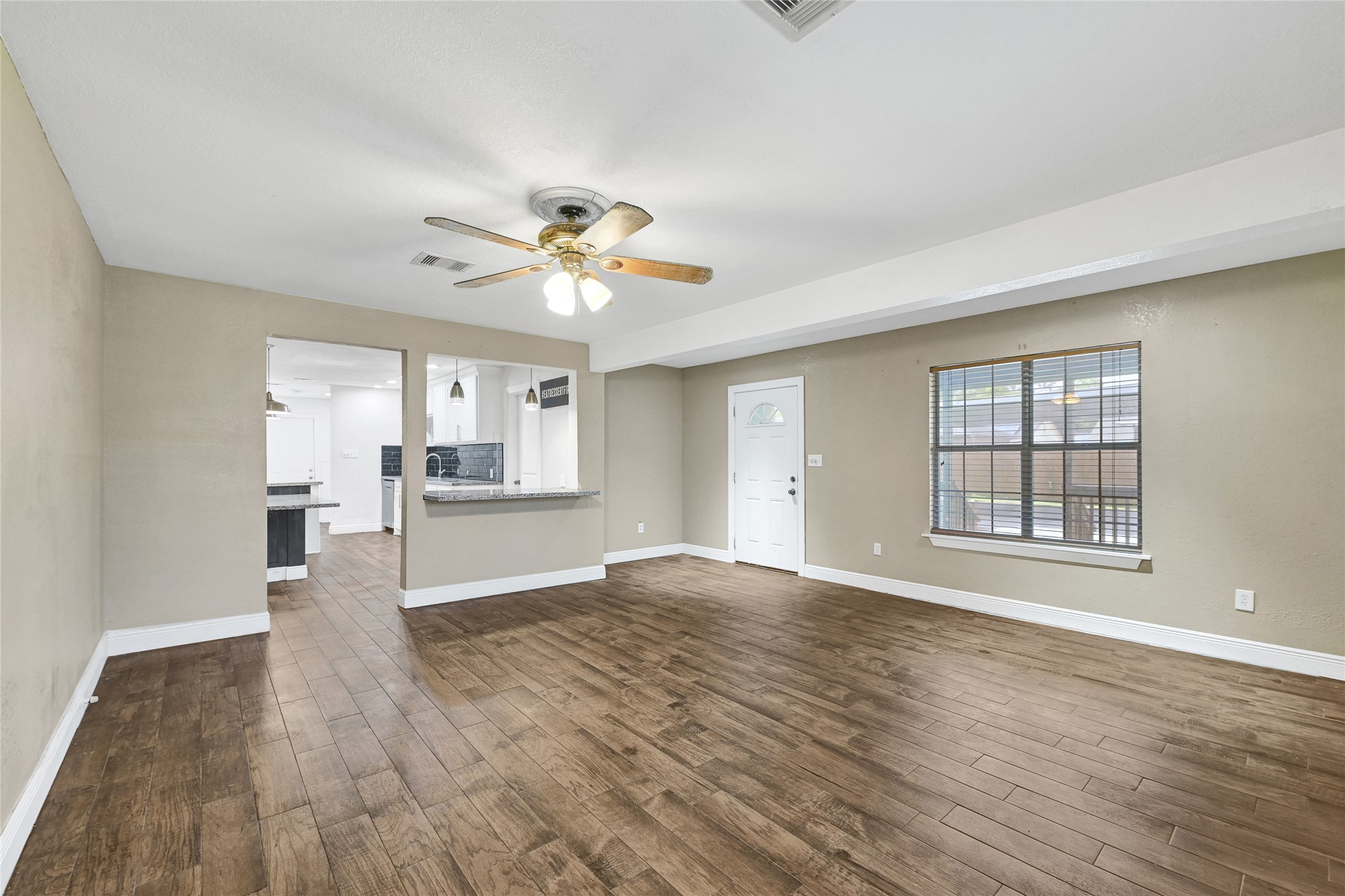 6825 Appleton Street Houston, TX 77022 - Photo 5 of 25 a view of an empty room with a kitchen and a window