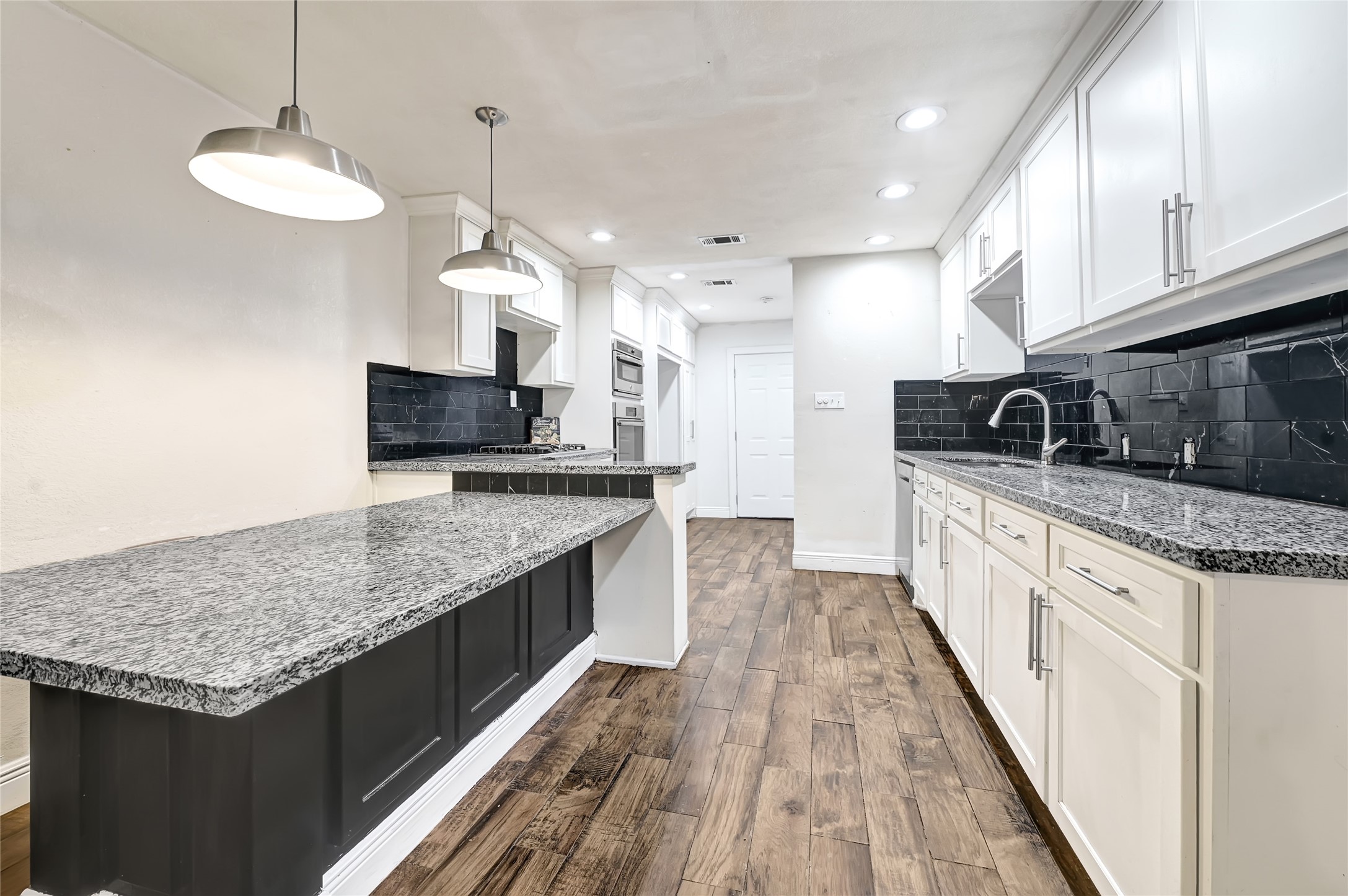 6825 Appleton Street Houston, TX 77022 - Photo 7 of 25 a kitchen with stainless steel appliances granite countertop a sink stove and refrigerator