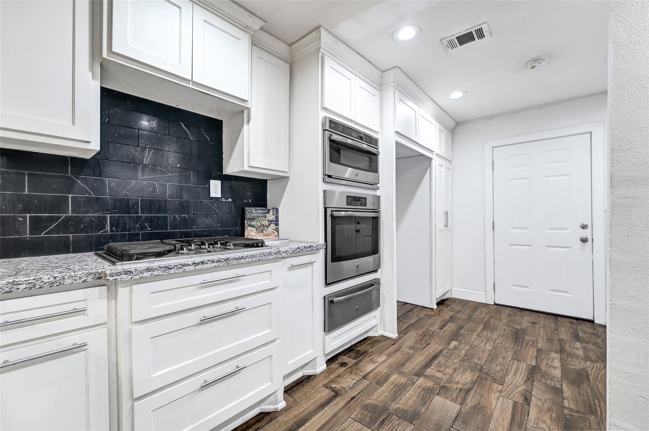 6825 Appleton Street Houston, TX 77022 - Photo 8 of 25 a kitchen with stainless steel appliances granite countertop a stove and a refrigerator