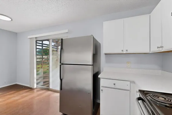 a view of cabinets and refrigerator