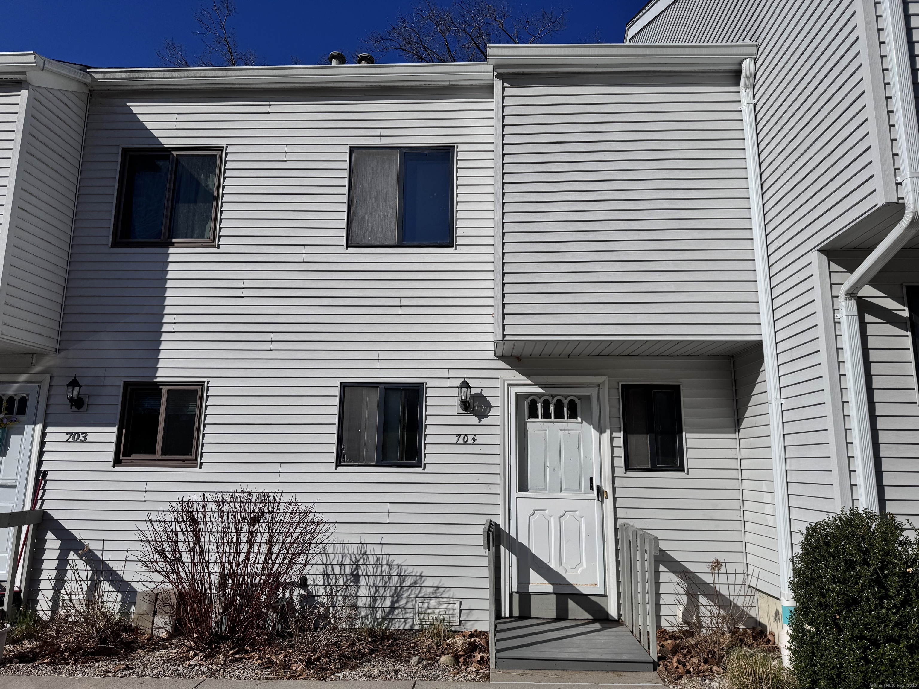 704 Timber Lane, Unit 704 Canton, CT 06019 - Photo 1 of 1 a view of a house with large windows