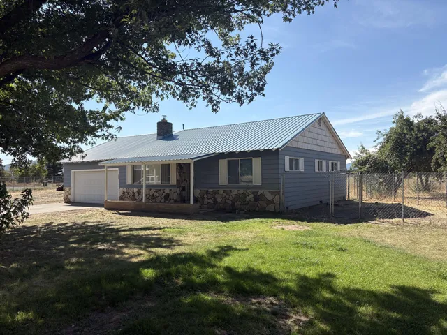 a front view of a house with yard and green space