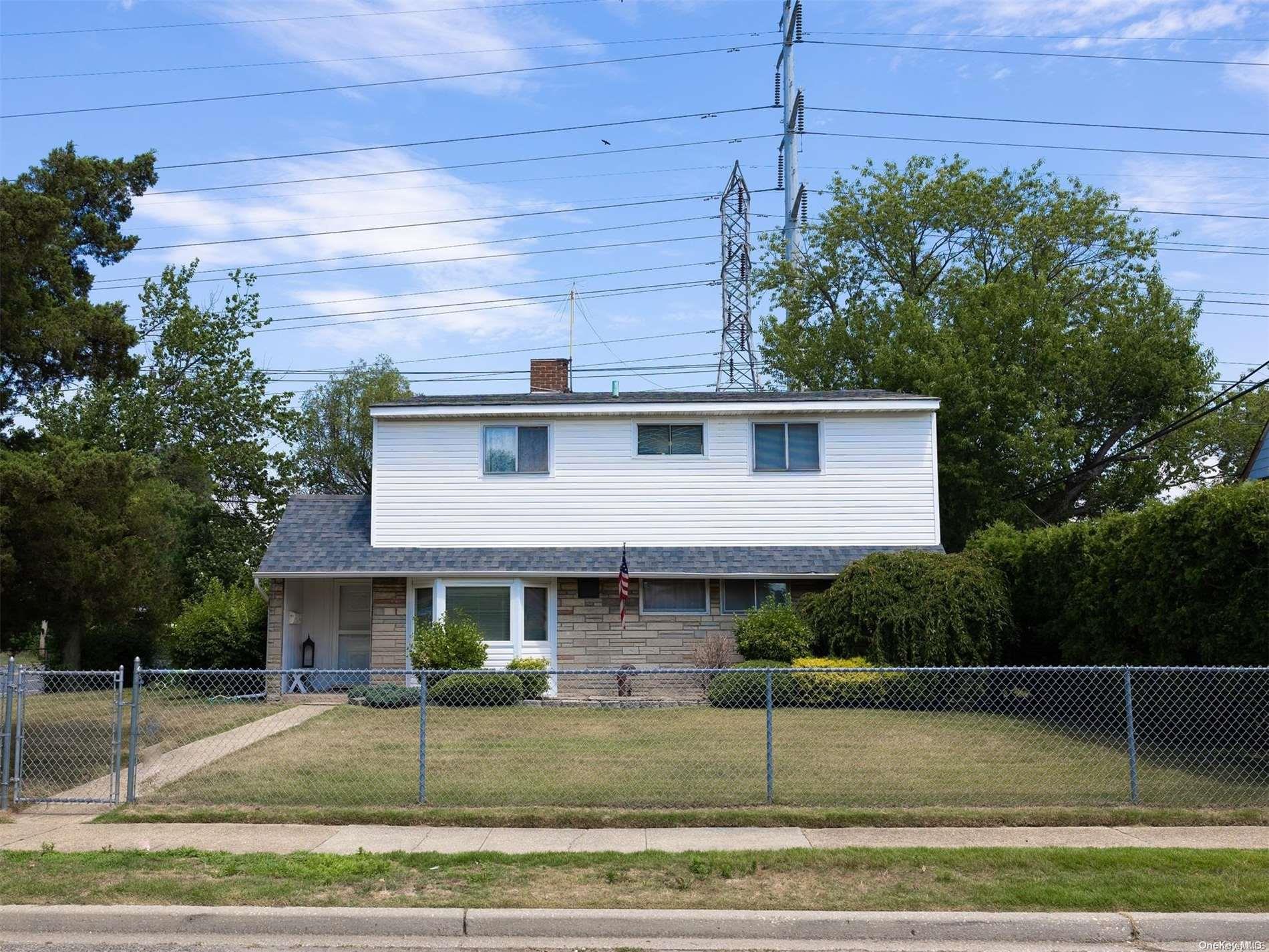 1 Mallard Road Levittown, NY 11756 - Photo 1 of 1 a view of a white house next to a yard