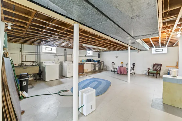a gym room with lots of furniture and a flat screen tv