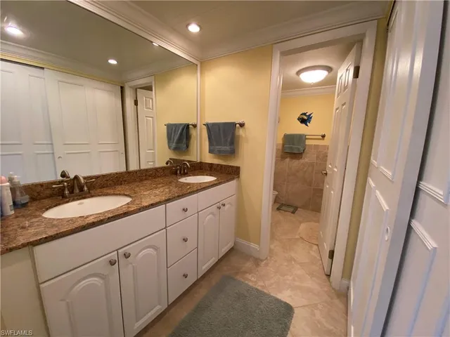 a spacious bathroom with a granite countertop sink mirror and shower