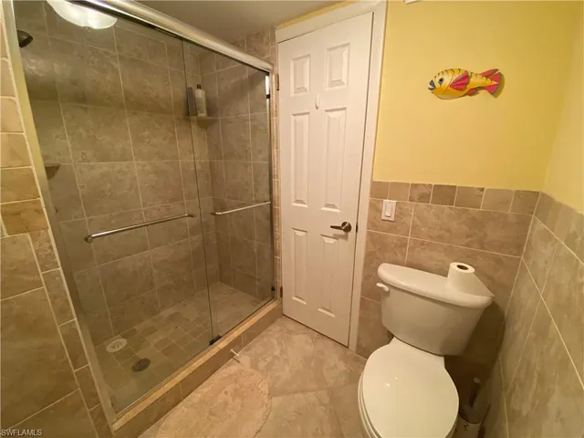 a bathroom with a toilet and shower