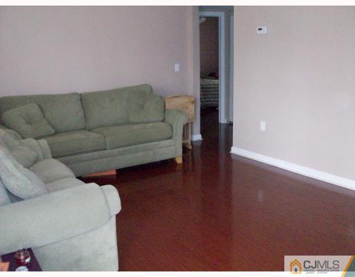 33 West Knollwood Road Edison, NJ 08817 - Photo 4 of 9 a living room with furniture and a wooden floor