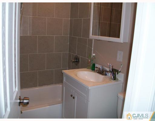 33 West Knollwood Road Edison, NJ 08817 - Photo 7 of 9 a bathroom with a sink a toilet and shower