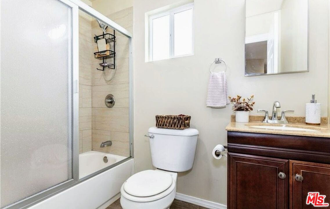 13447 Filmore Street Pacoima, CA 91331 - Photo 11 of 12 a bathroom with a sink a toilet and shower