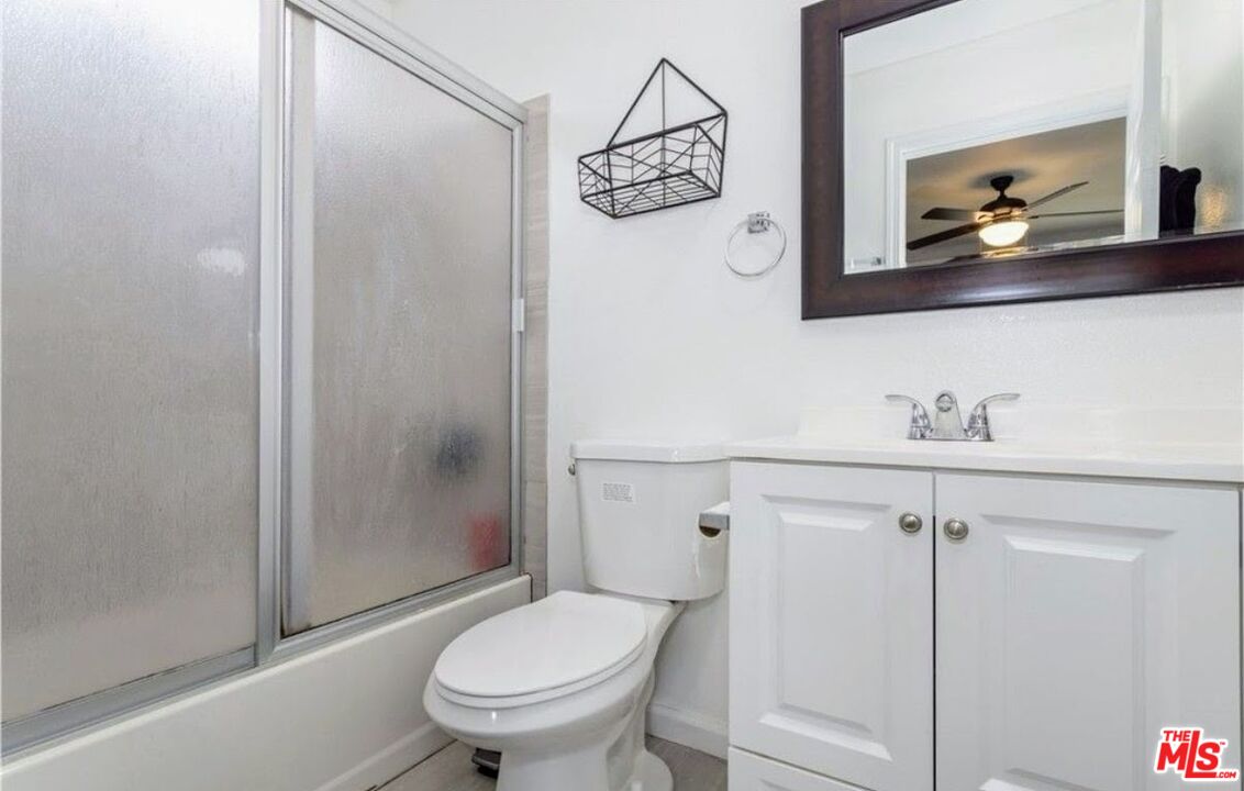 13447 Filmore Street Pacoima, CA 91331 - Photo 12 of 12 a bathroom with a toilet a sink and shower