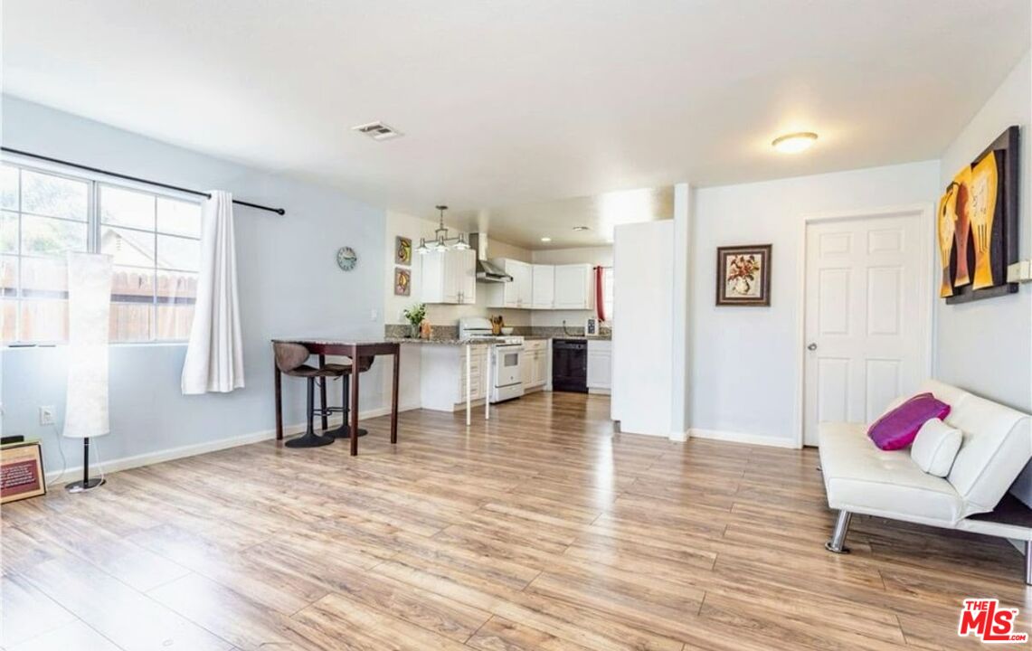 13447 Filmore Street Pacoima, CA 91331 - Photo 2 of 12 a living room with furniture and kitchen view