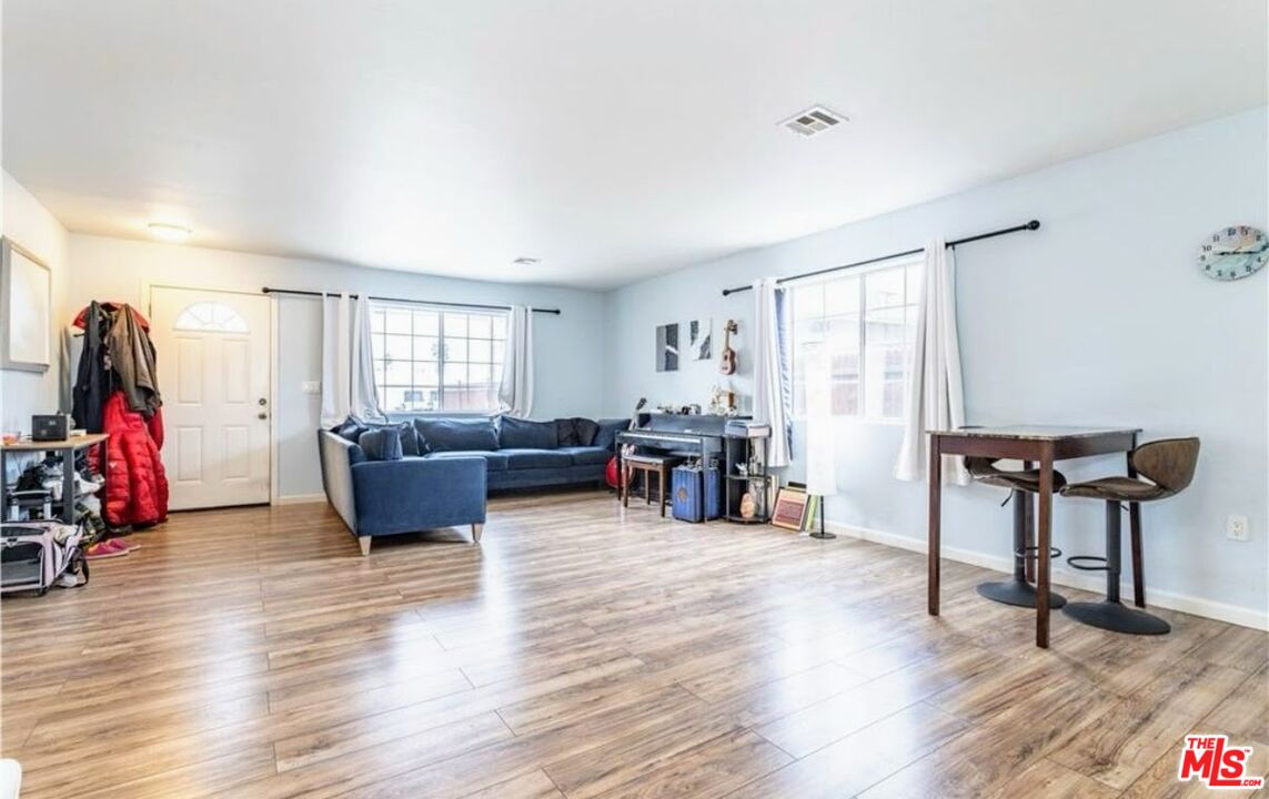 13447 Filmore Street Pacoima, CA 91331 - Photo 5 of 12 a living room with furniture and a wooden floor
