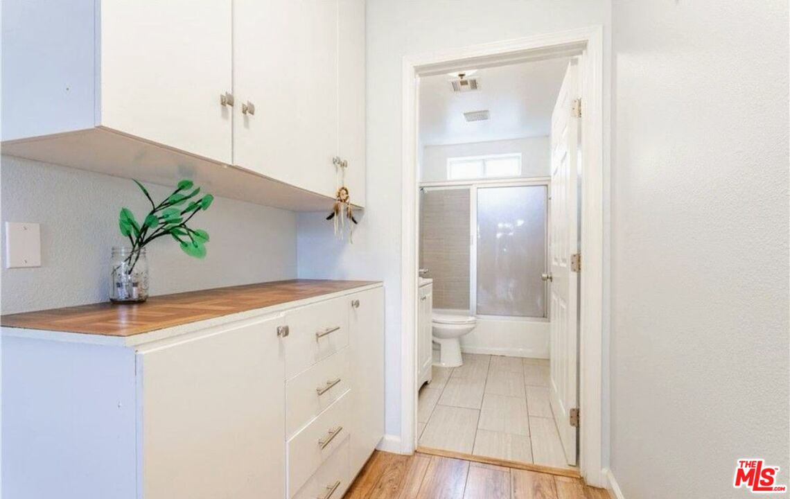 13447 Filmore Street Pacoima, CA 91331 - Photo 7 of 12 a view of bathroom with a potted plant on a sink and a toilet