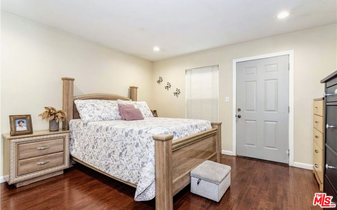 13447 Filmore Street Pacoima, CA 91331 - Photo 10 of 12 a bedroom with a bed and a couch