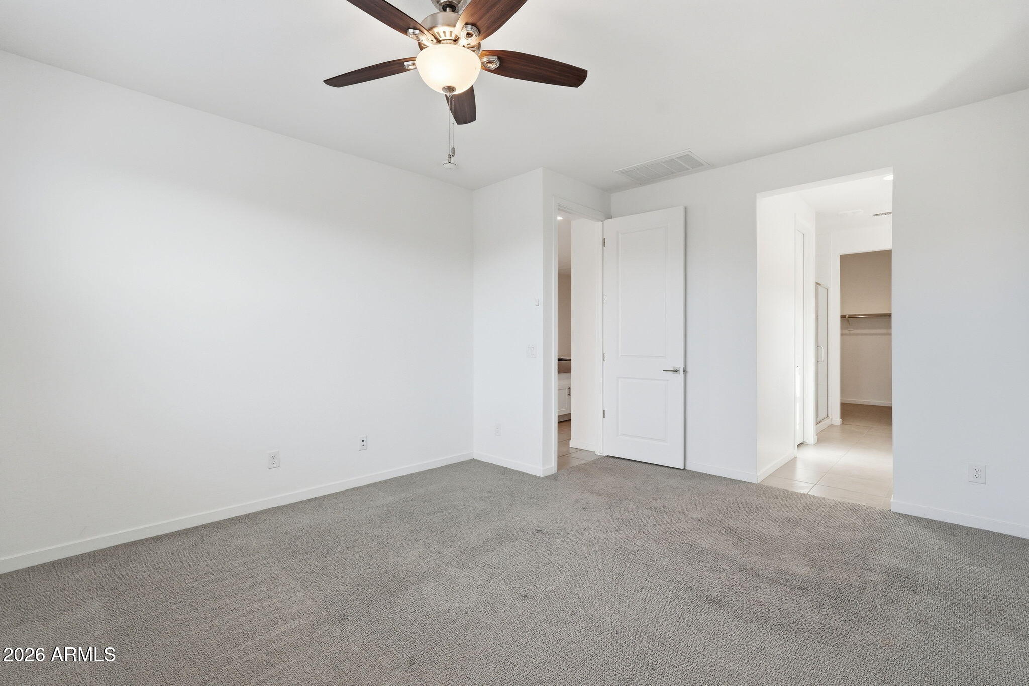 5621 West Notch Hill Road Laveen, AZ 85339 - Photo 18 of 49 an empty room with a chandelier fan and a ceiling fan