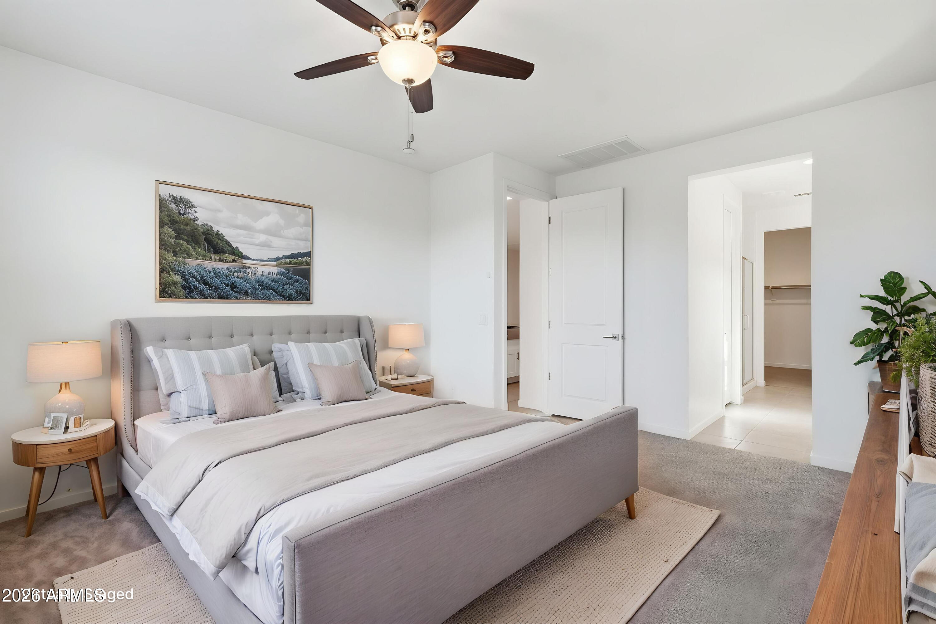 5621 West Notch Hill Road Laveen, AZ 85339 - Photo 19 of 49 a spacious bedroom with a bed and a chandelier