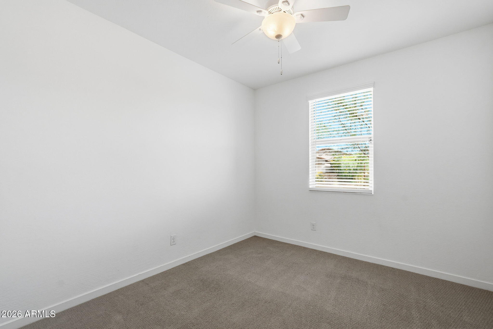 5621 West Notch Hill Road Laveen, AZ 85339 - Photo 25 of 49 an empty room with a chandelier fan