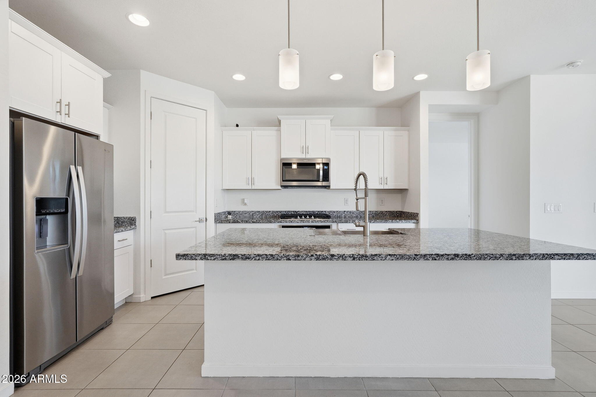 5621 West Notch Hill Road Laveen, AZ 85339 - Photo 6 of 49 a kitchen with stainless steel appliances granite countertop a sink a refrigerator and a granite counter tops