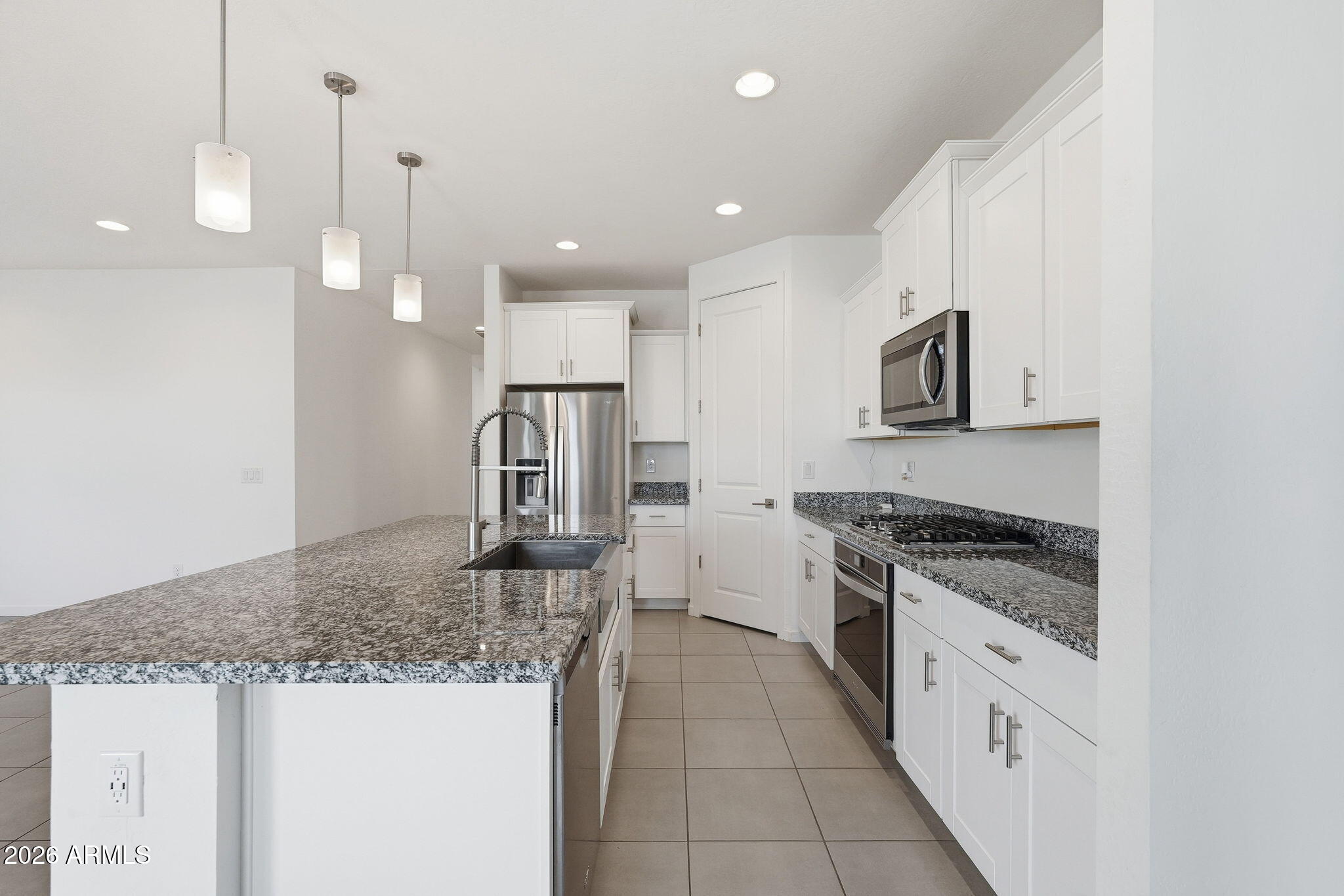 5621 West Notch Hill Road Laveen, AZ 85339 - Photo 7 of 49 a large kitchen with granite countertop a sink a counter top space appliances and cabinets