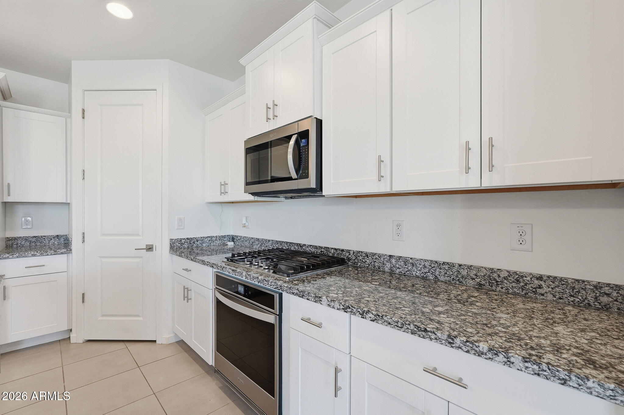 5621 West Notch Hill Road Laveen, AZ 85339 - Photo 8 of 49 a kitchen with granite countertop white cabinets and stainless steel appliances