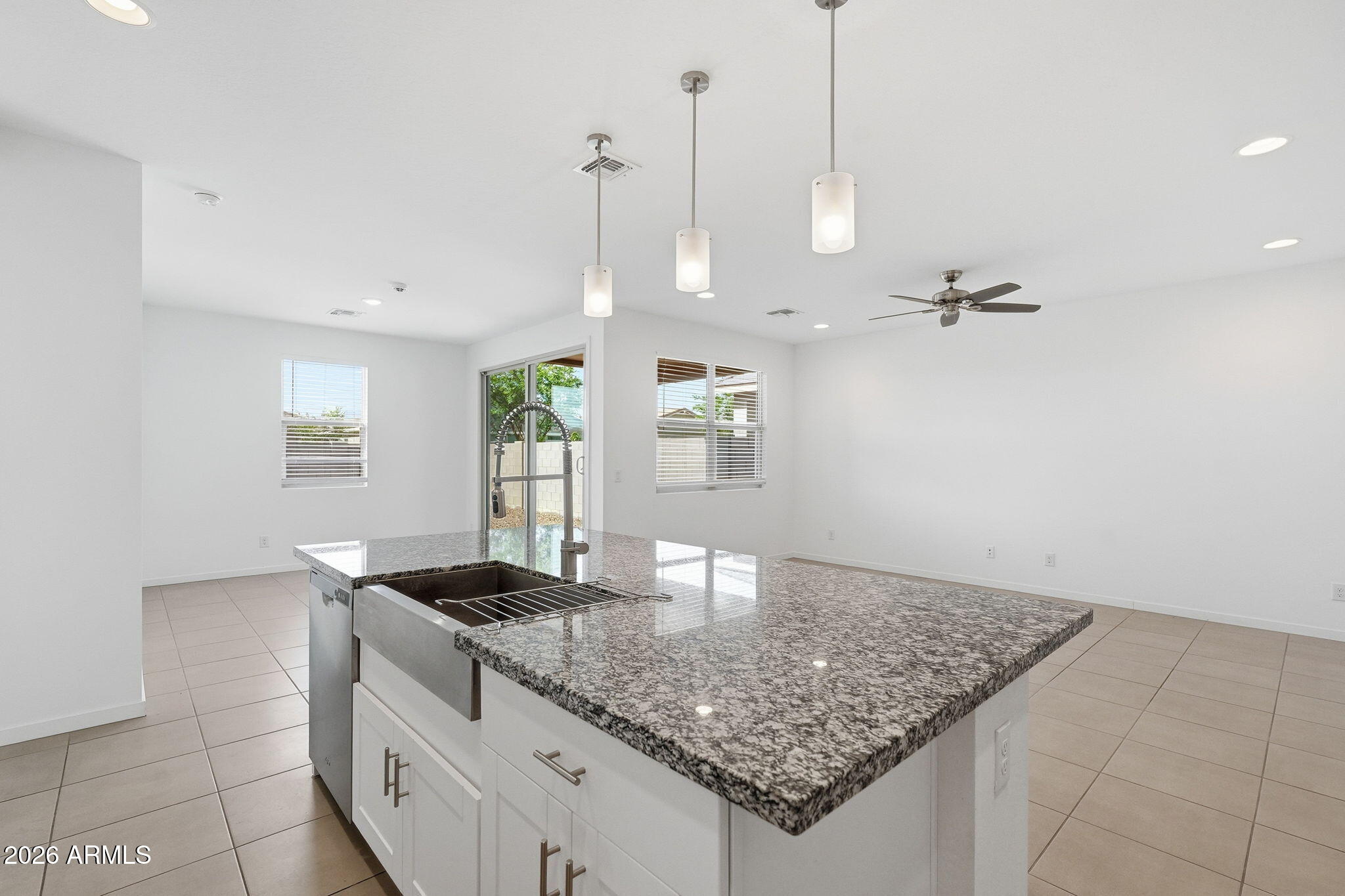 5621 West Notch Hill Road Laveen, AZ 85339 - Photo 10 of 49 a kitchen with kitchen island a counter top space a sink and appliances