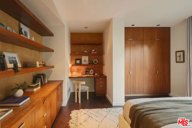 a bedroom with a bed and a table in it