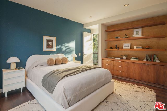 a large bed sitting in a bedroom next to a cabinet