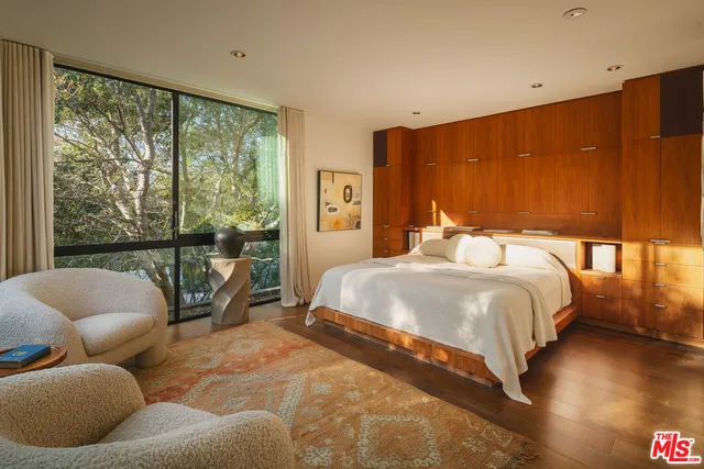 a bedroom with a bed and glass window