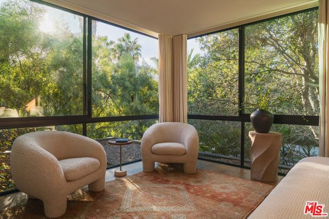 a outdoor living space with furniture and a floor to ceiling window