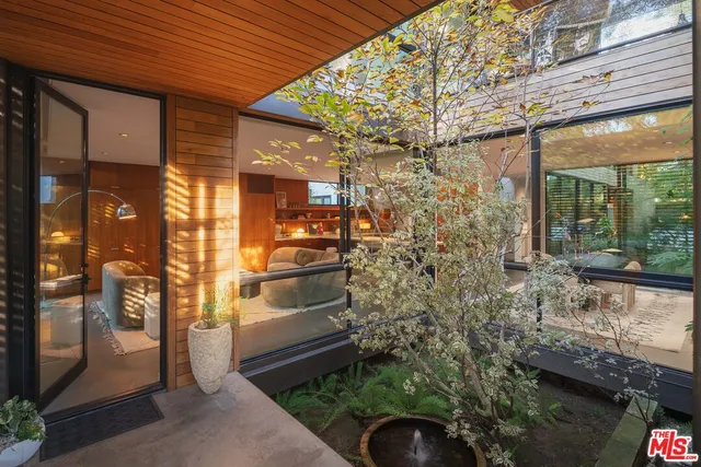 a view of a patio with table and chairs and potted plants