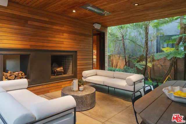 a outdoor living space with patio furniture and a fireplace