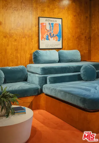 a blue couch sitting next to a blue wall