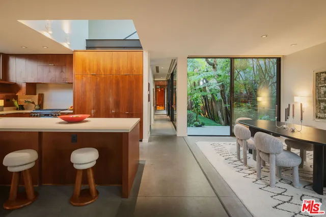 a living room with furniture a rug and a large window