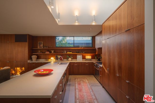 a kitchen with a sink and wooden cabinets