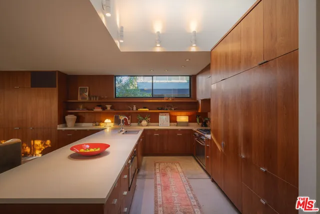 a kitchen with a sink and wooden cabinets