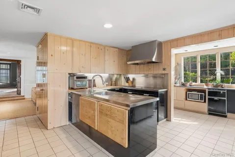 a kitchen with a stove top oven sink and cabinets